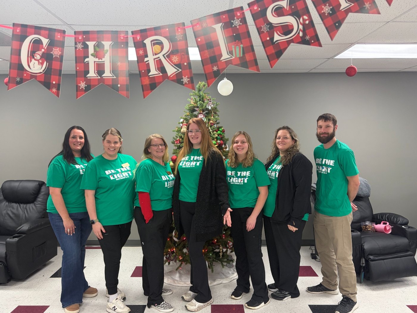 The Golden Years team in Be the Light shirts at a holiday gathering